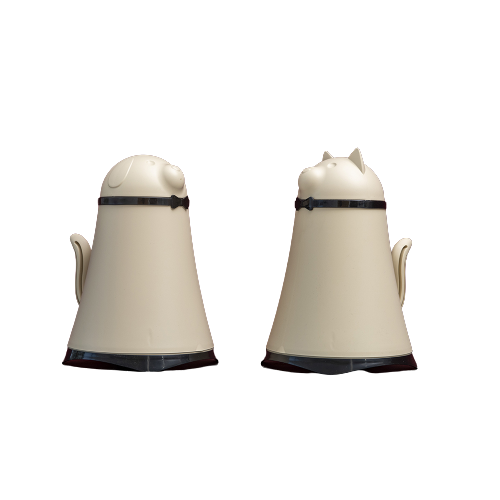 a pair of creamer with black handles and black trim