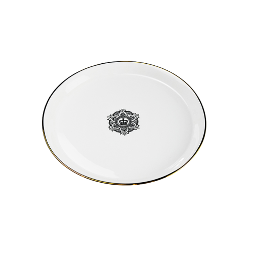 white porcelain plate with gold rim and a mandala design in the centre