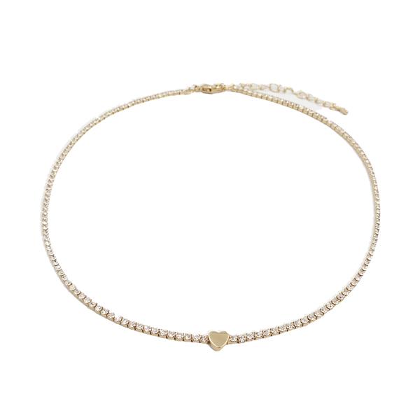 a gold filled beaded bracelet with a gold heart charm