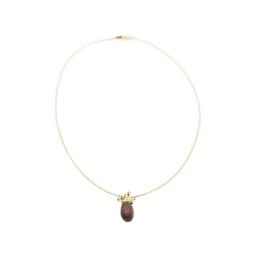 a gold filled choker necklace with a brown stone