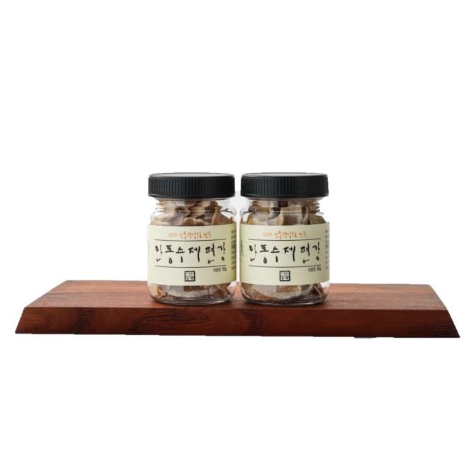 two jars of sea salt on a wooden board