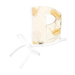 the organic cotton muslin swaddle bag in the color white with a white tie and a tag that says organic