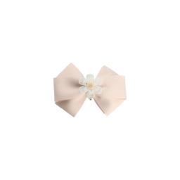 a light pink hair bow with a white flower