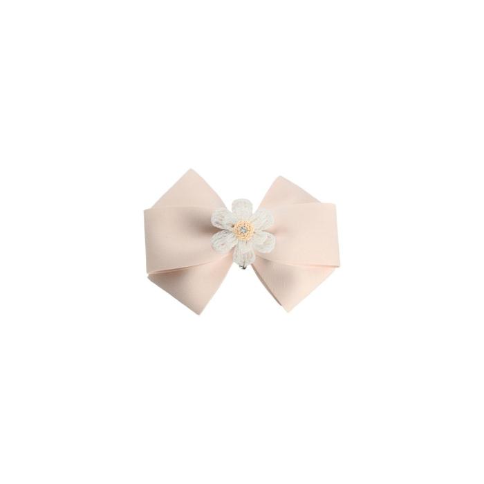 a light pink hair bow with a white flower