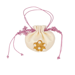 a white pouch with a gold flower and pink lace