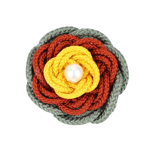 a crochet flower with a pearl in the center