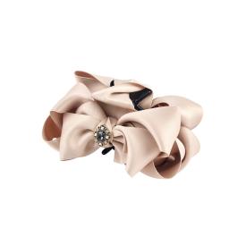 a pink bow and a brooch