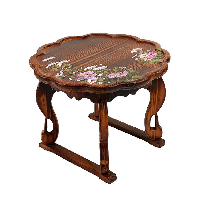 a wooden table with flowers on it