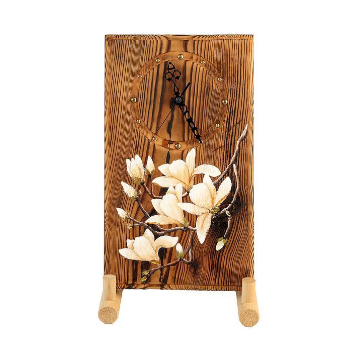 a wooden clock with magnolia flowers