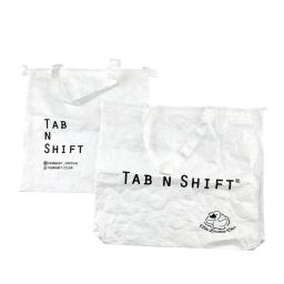 the tab n shift logo and a white tote bag