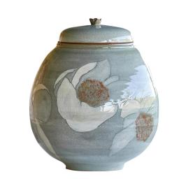 this image stands for: large ceramic jar with lid and flowers
