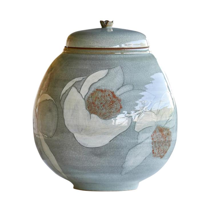 this image stands for: large ceramic jar with lid and flowers