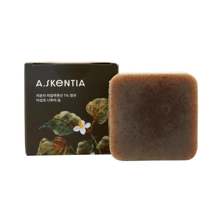 A box and a bar of soap with green leaves on it