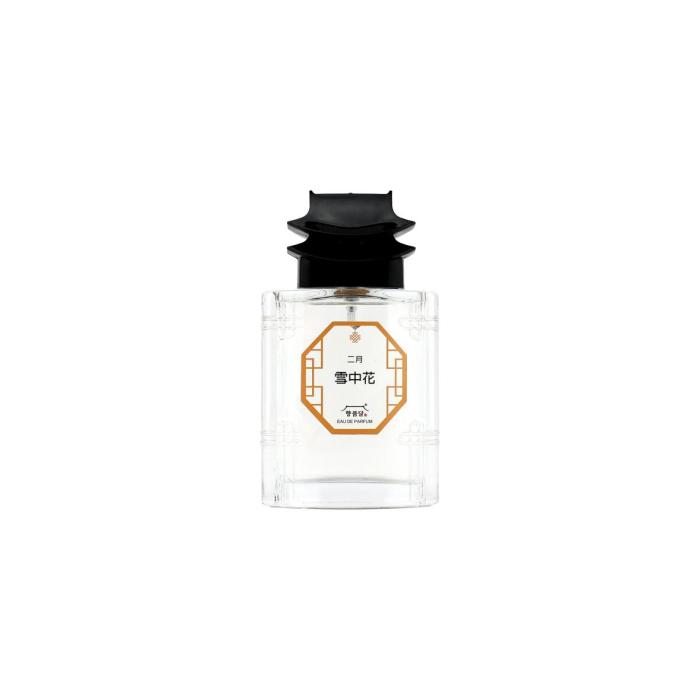 perfume bottle with black cap and white label