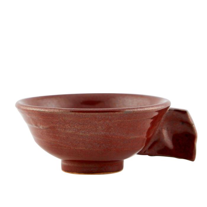 a small red tea cup