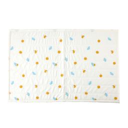 a white quilt with blue and yellow flowers