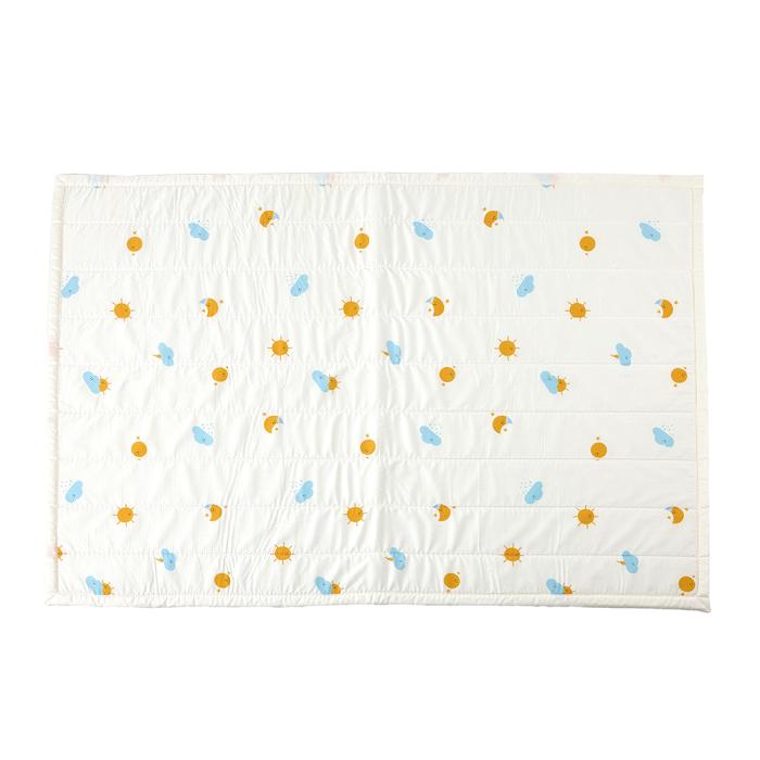 a white quilt with blue and yellow flowers
