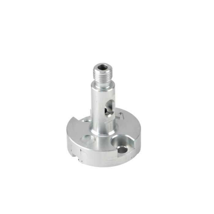 A precision-machined aluminum metal component with a compact cylindrical base and a raised threaded shaft, presented like an industrial hardware part. Its brushed silver finish, clean cutouts, and smooth turned surfaces emphasize engineering accuracy and durability. The visible holes, slots, and layered geometry suggest a functional mounting or connector piece made for exact fit and performance, appealing to technical buyers who value reliability and craftsmanship.