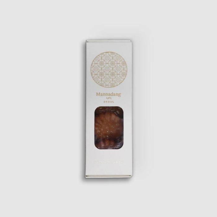 White matte paper packaging featuring a gold traditional Korean emblem.