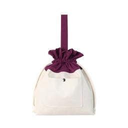 the white and purple bag with a bow and a pocket on the front