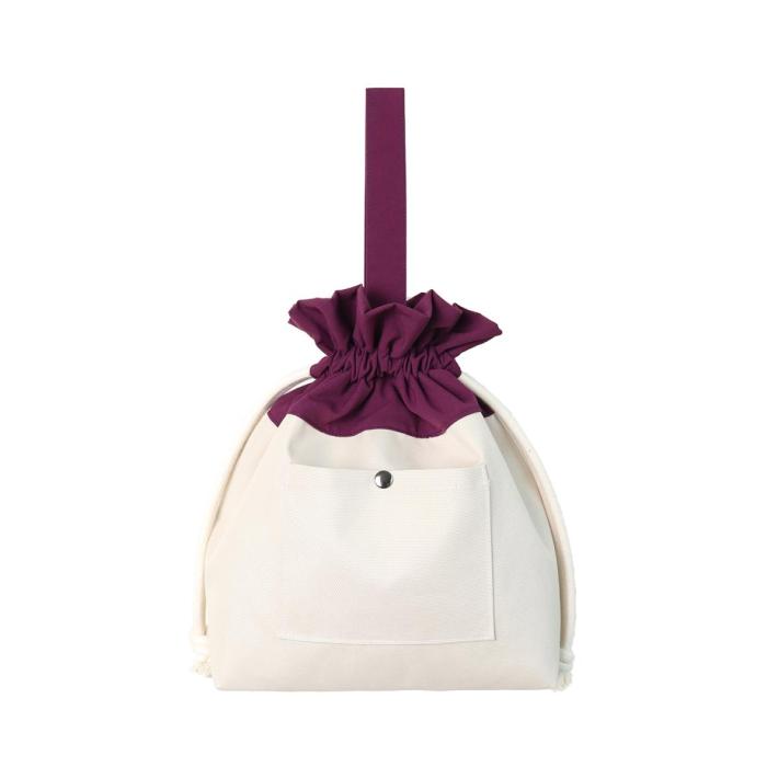 the white and purple bag with a bow and a pocket on the front