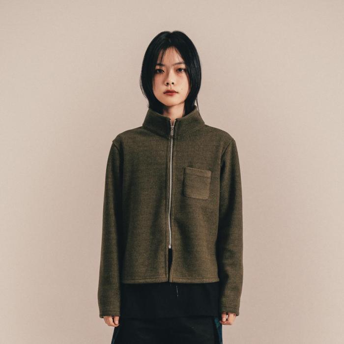 this image stands for: woman in green jacket