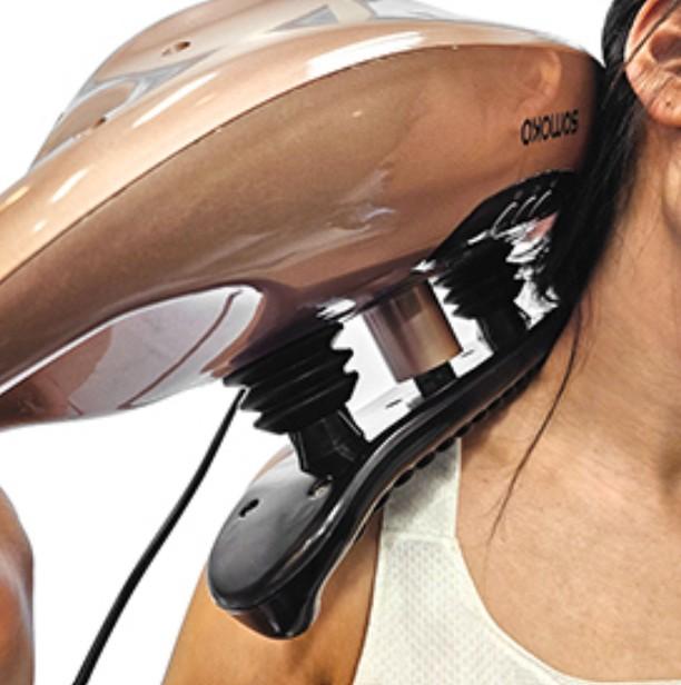 woman using a massager on her neck