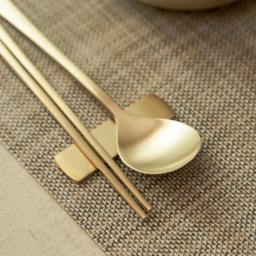 Elegant display of the NOBBAN Bangjja Yugi Bronze 2 Person Spoon Premium Gift Set, showcasing its refined golden bronze finish and handcrafted details.