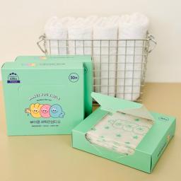 laundry color catcher sheets in color box packaging. Neatly stacked laundry basket in background.