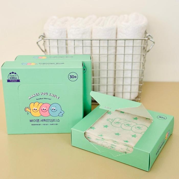 laundry color catcher sheets in color box packaging. Neatly stacked laundry basket in background.