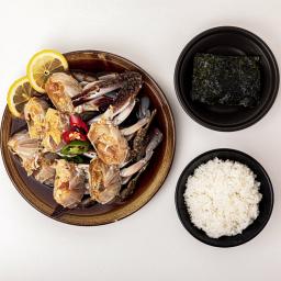 grilled squid on a plate with rice and seaweed salad