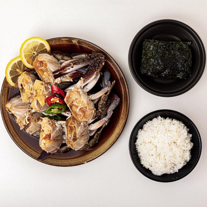 grilled squid on a plate with rice and seaweed salad