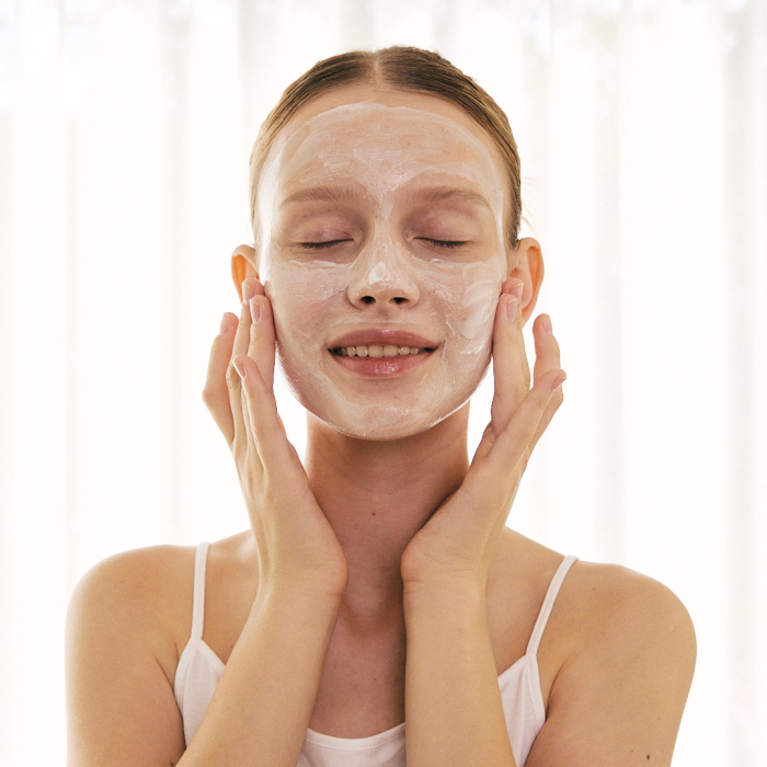 woman applying a face mask