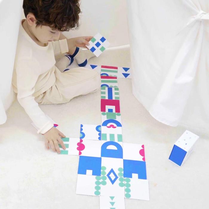 boy playing with blue and green puzzle