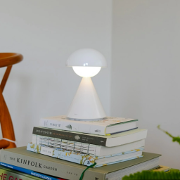 a stack of books and a lamp
