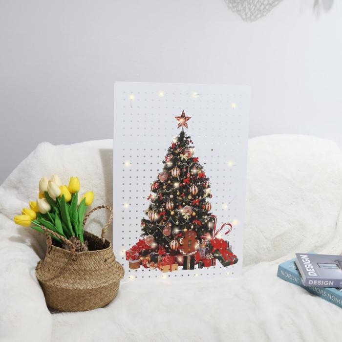Pegboard printed with a Christmas tree design, decorated with LED lights, placed on a sofa with a basket of flowers for cozy seasonal ambiance.