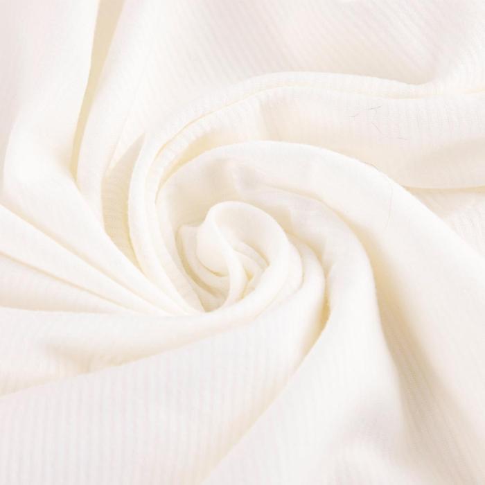 a close up of a cream colored piece of fabric