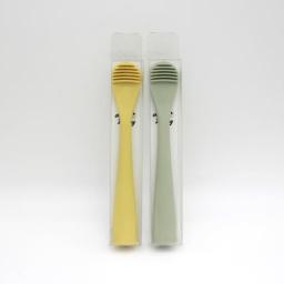green and yellow toothbrushes
