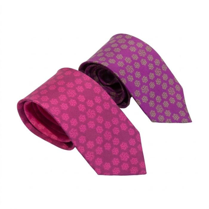 pink silk tie with a floral design and a purple silk tie with a floral pattern
